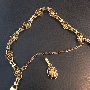 Gold bracket w/ black bird and a necklace pendant